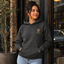 Woman wearing charcoal King Eddie Heritage Hoodie with gold crest logo outside a café